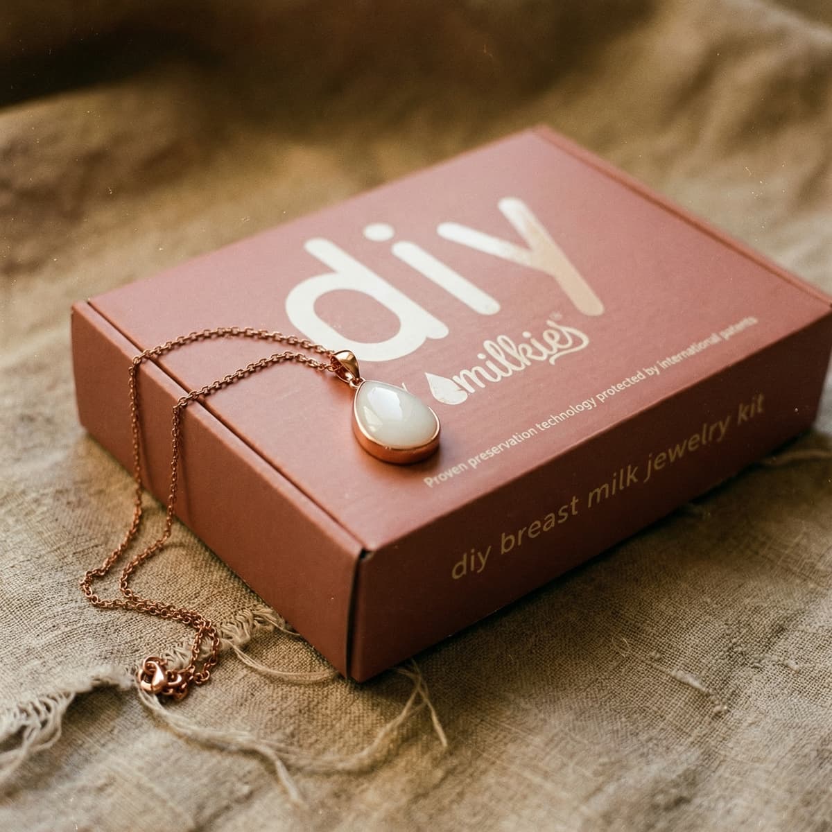 Rose-gold DIY by MILKIES breast milk jewelry kit box featuring a teardrop pendant necklace, an elegant option for unique push presents and keepsake breastmilk resin jewelry