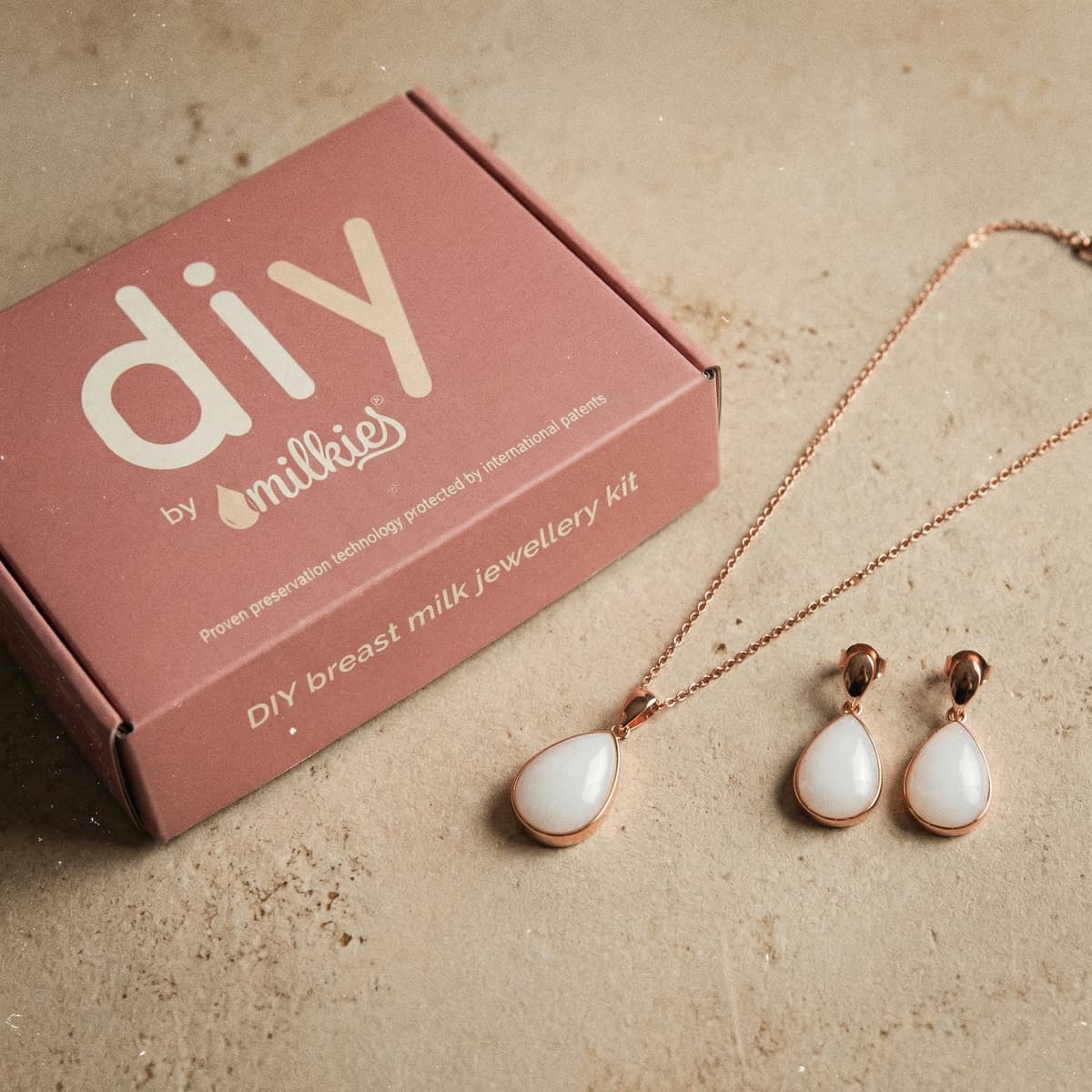 Rose-gold teardrop breast milk jewelry kit box by DIY by MILKIES with matching necklace and earrings, a meaningful DIY keepsake idea for new mom gifts for pregnant women.